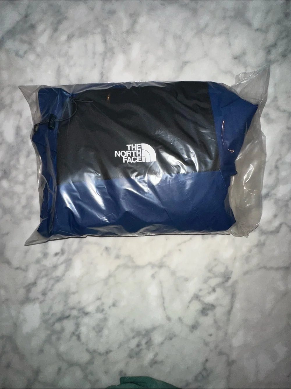 The North Face Blue and Black Hooded Rain Jacket